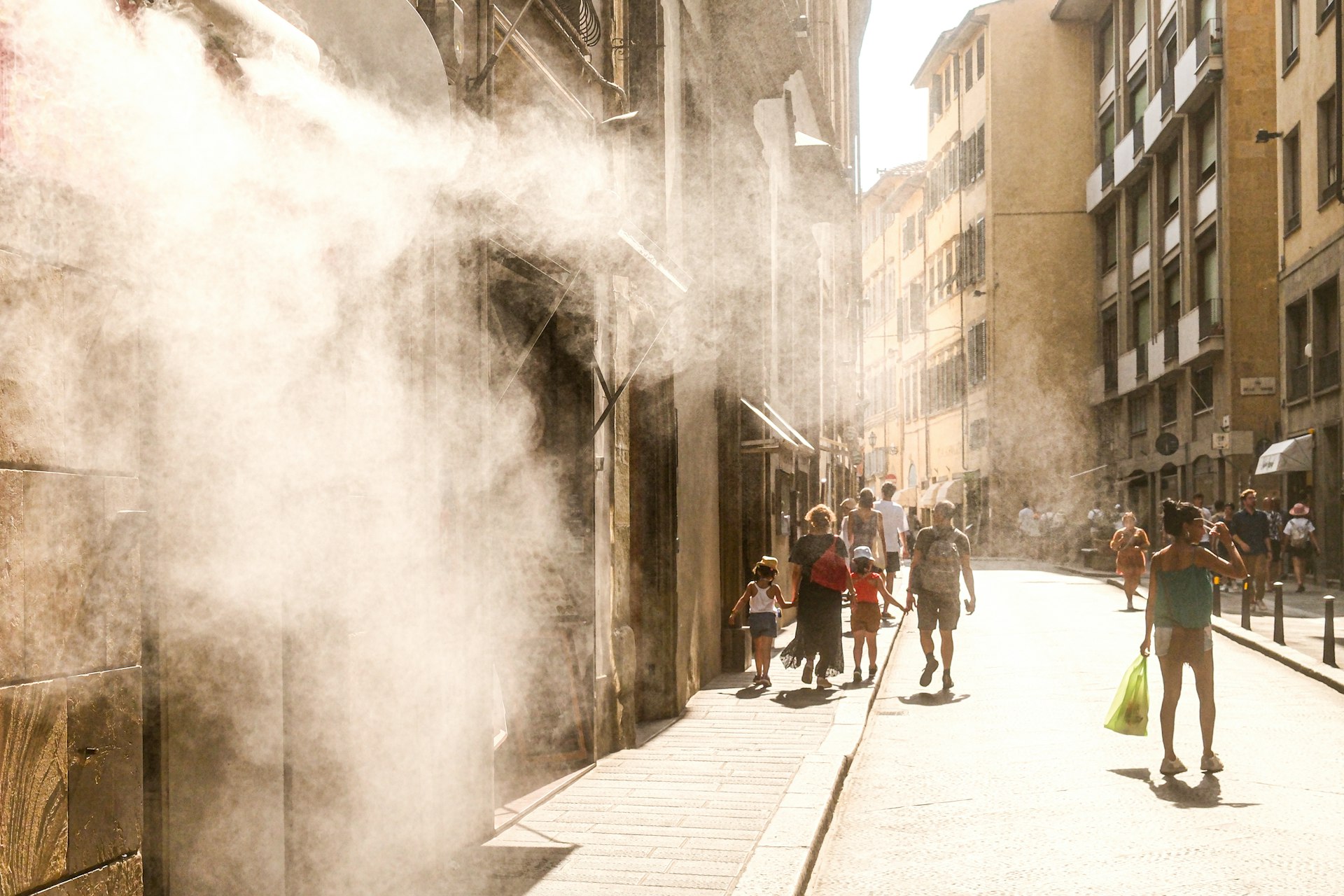 Urban street during summer heatwave with people seeking relief from extreme heat