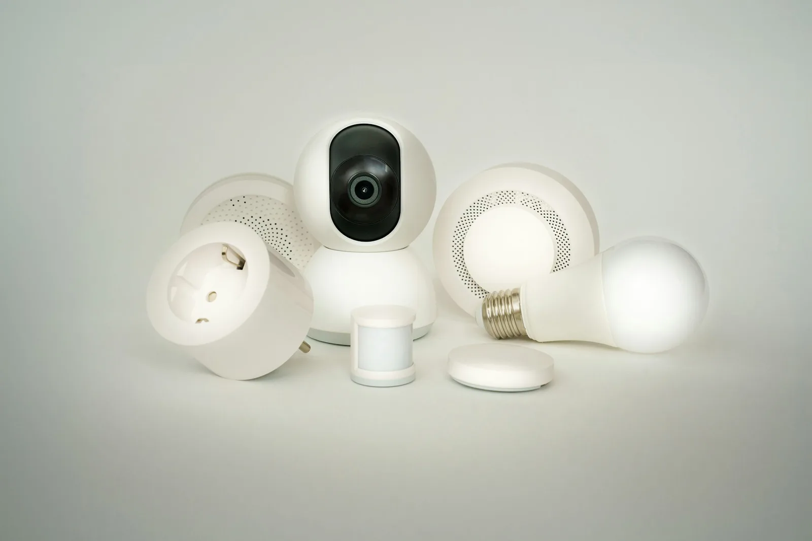 Smart home hub and automation devices arranged on a white surface