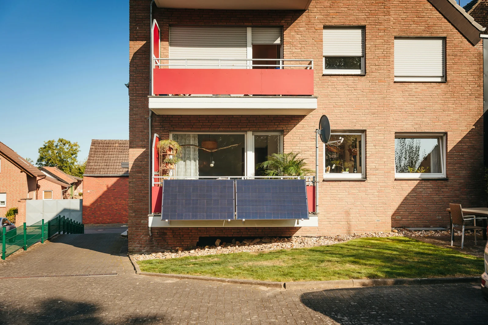 Modern apartment complex balconies in Berlin equipped with standardized black solar panels