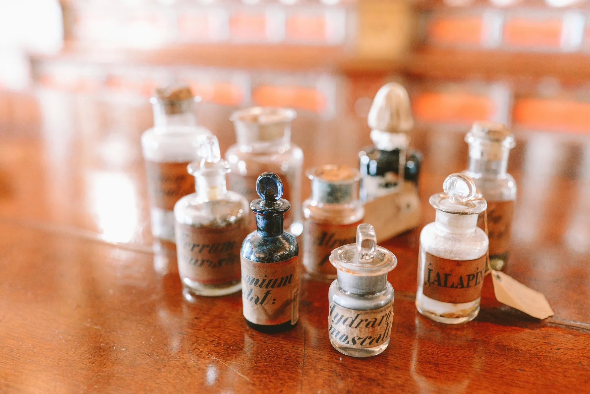 Overhead array of amber glass apothecary dropper vials and tinctures