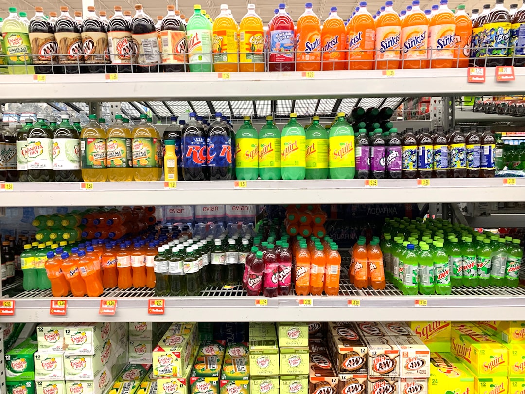 Refrigerated grocery store shelf display with probiotic soda bottles including Health-Ade, GTs, and Reeds varieties